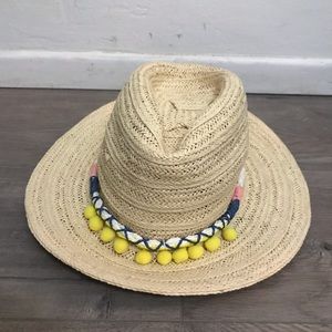 Straw hat with poofs and crochet